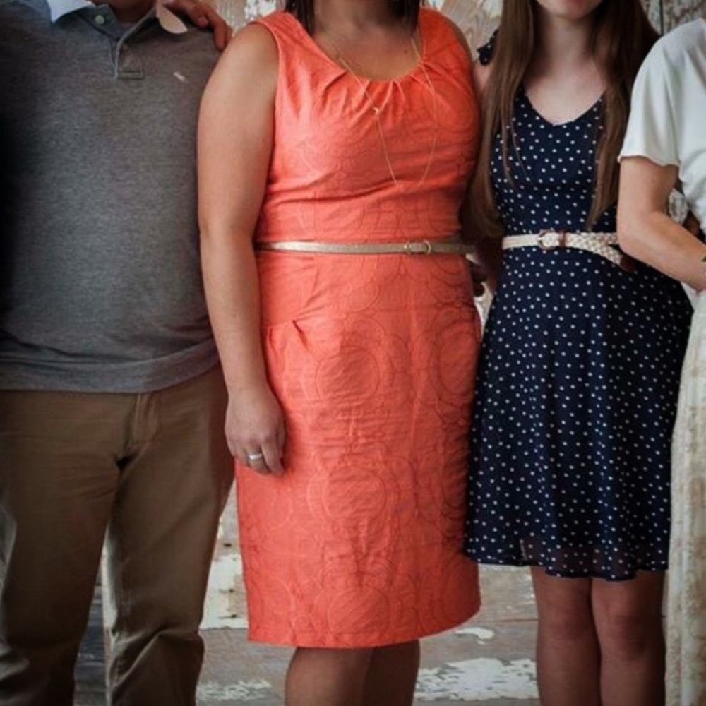 Coral dress with embossed pattern and pock…